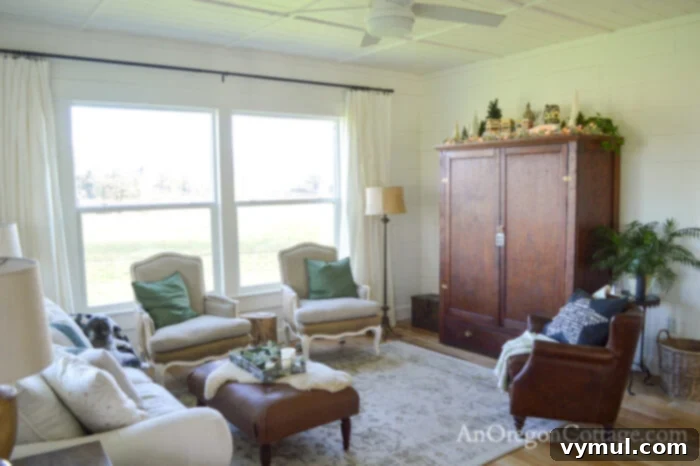 Farmhouse living room with a decorated cabinet for Christmas