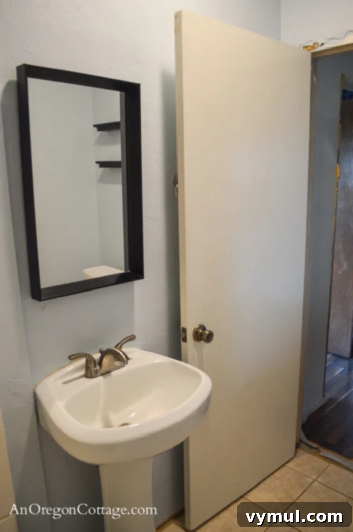 1900 Farmhouse Main Bathroom: Classic Charm Reimagined 15 Farmhouse main floor bath BEFORE-sink-door