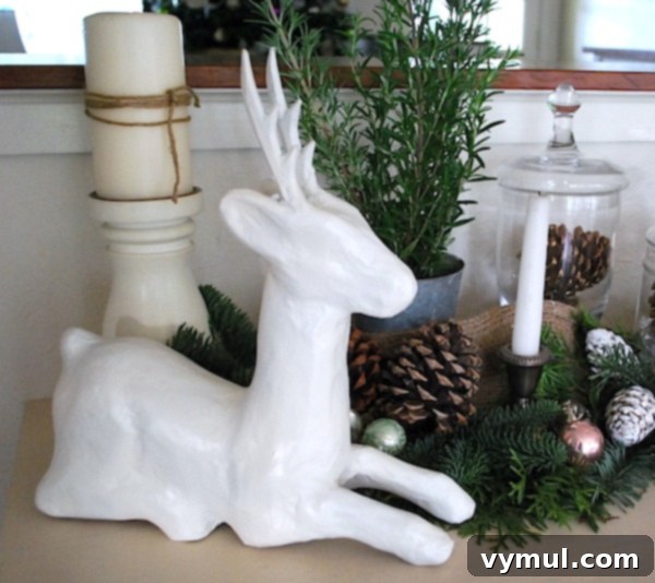After: Transformed white paper mache deer, dignified and modern, ready for holiday display