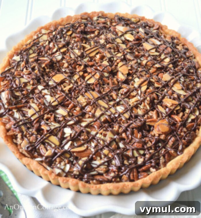 Easy Honey Caramel Triple Nut Tart 8 A top-down view of the beautifully decorated Honey Caramel Triple Nut Tart.