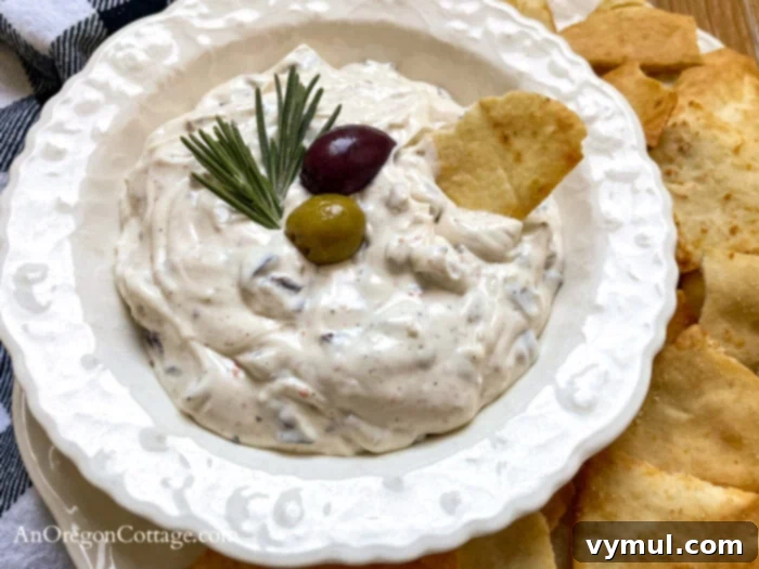 Velvety Roasted Olive Spread 3 roasted olive dip in bowl with pita