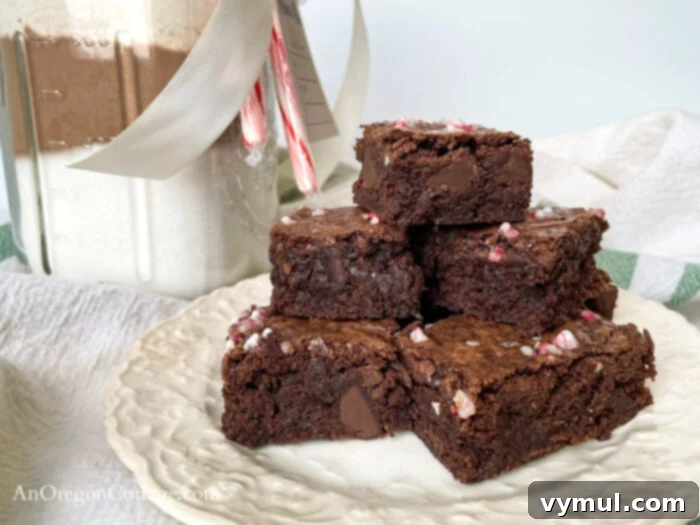 Plate of baked peppermint fudge brownies next to the brownie mix jar.