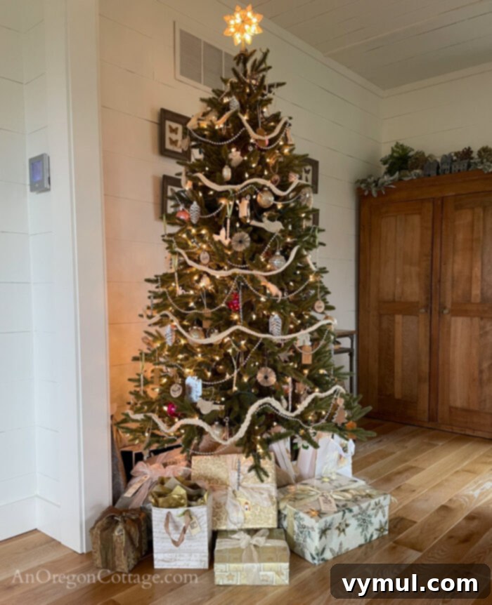 57 Must-Haves & Musings: Holiday Joy, Word of the Year, Lip Relief, and Great Reads 4 Christmas tree adorned with beautifully wrapped gifts using a color-coordinated system.