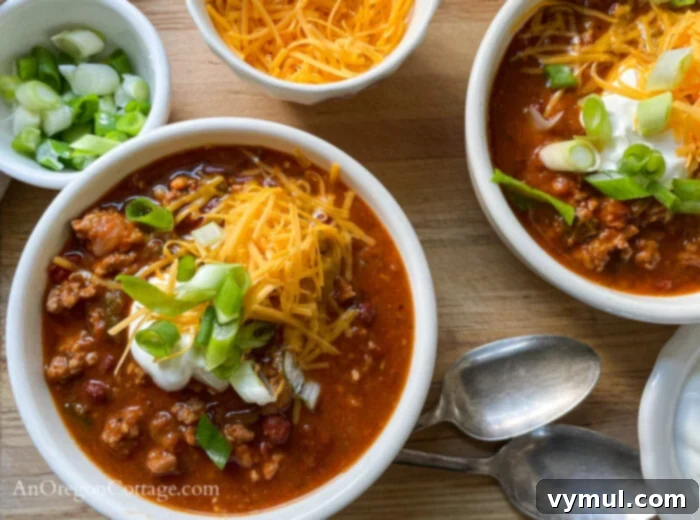 Effortless Chili For Any Cooker 3 chili in bowls above with toppings