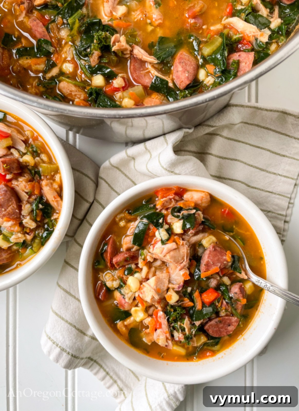 Quick Cajun Chicken Barley Harvest Soup 8 Cajun Chicken Barley Vegetable Soup above with spoon in bowl with large pot.