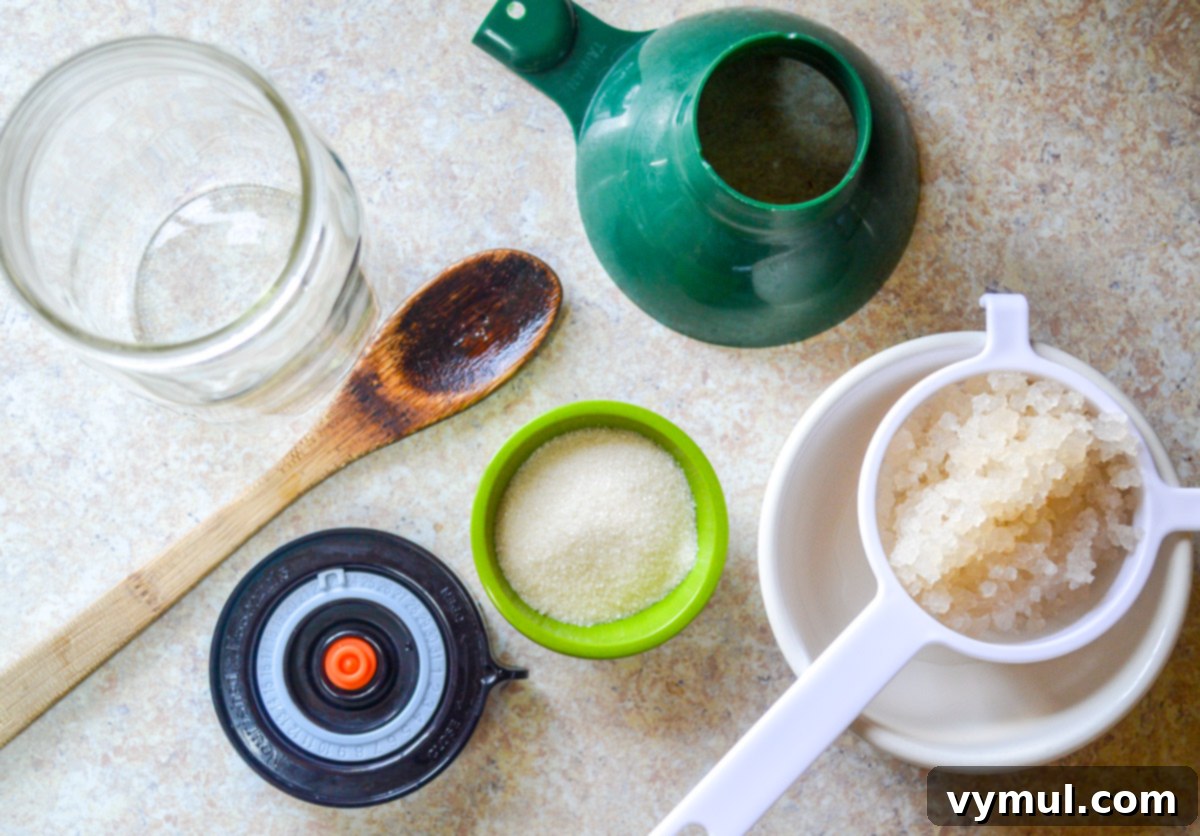Homemade Water Kefir Made Easy 3 Water kefir brewing supplies including jars, strainer, and sugar