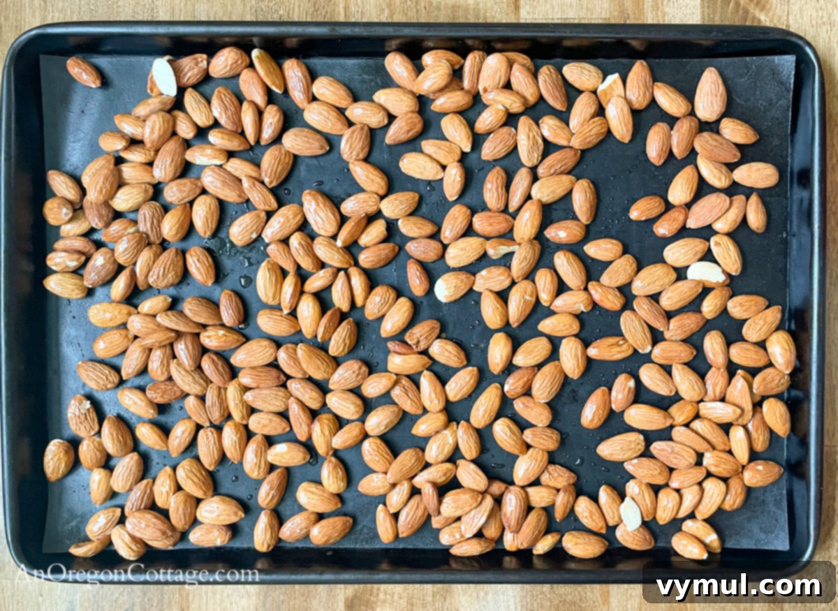 Chipotle Fire Almonds: Quick & Sugar-Free 5 salt water coated almonds spread on a baking sheet, ready for the oven