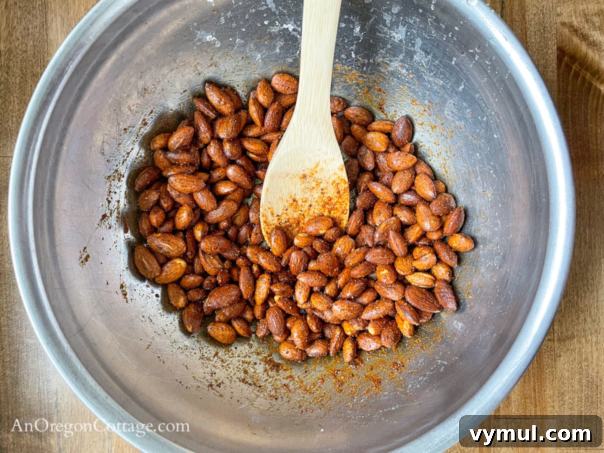 Chipotle Fire Almonds: Quick & Sugar-Free 6 mixing spices onto baked almonds in a bowl to ensure even coating