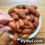 Chipotle Fire Almonds: Quick & Sugar-Free 9 grabbing chipotle spicy almonds from bowl