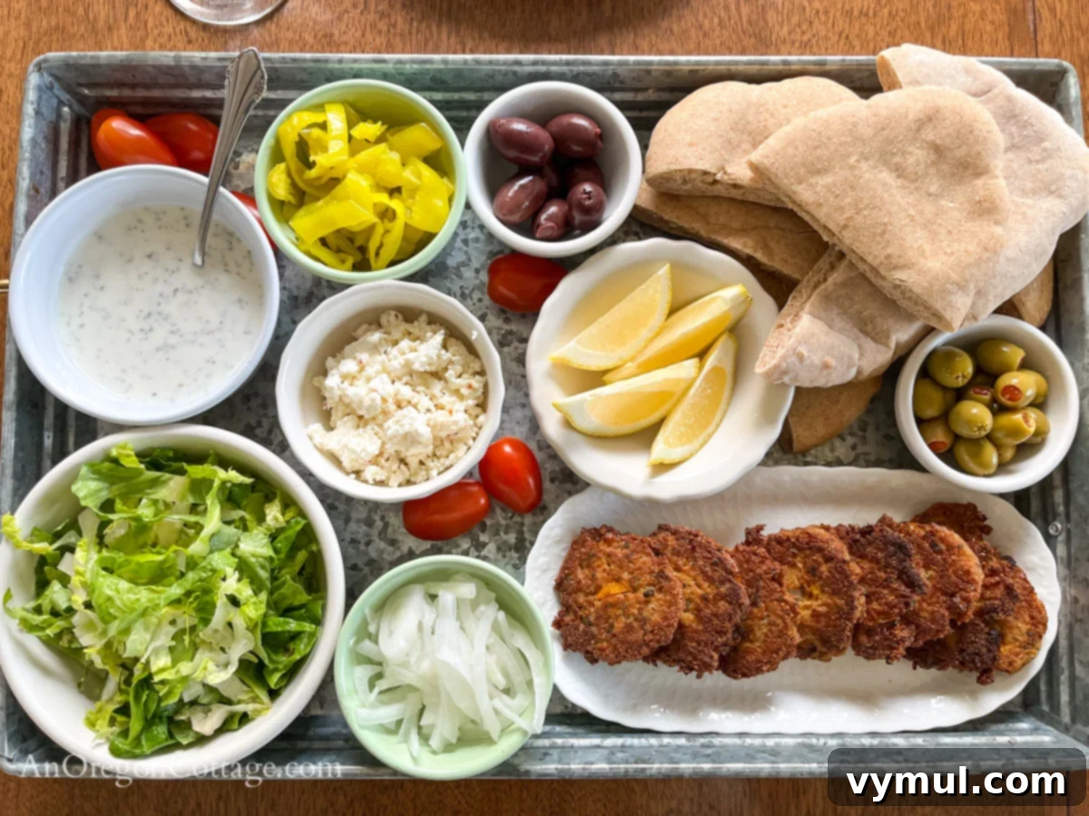 Overhead view of a Mediterranean tuna patty pita board with all components ready for assembly.