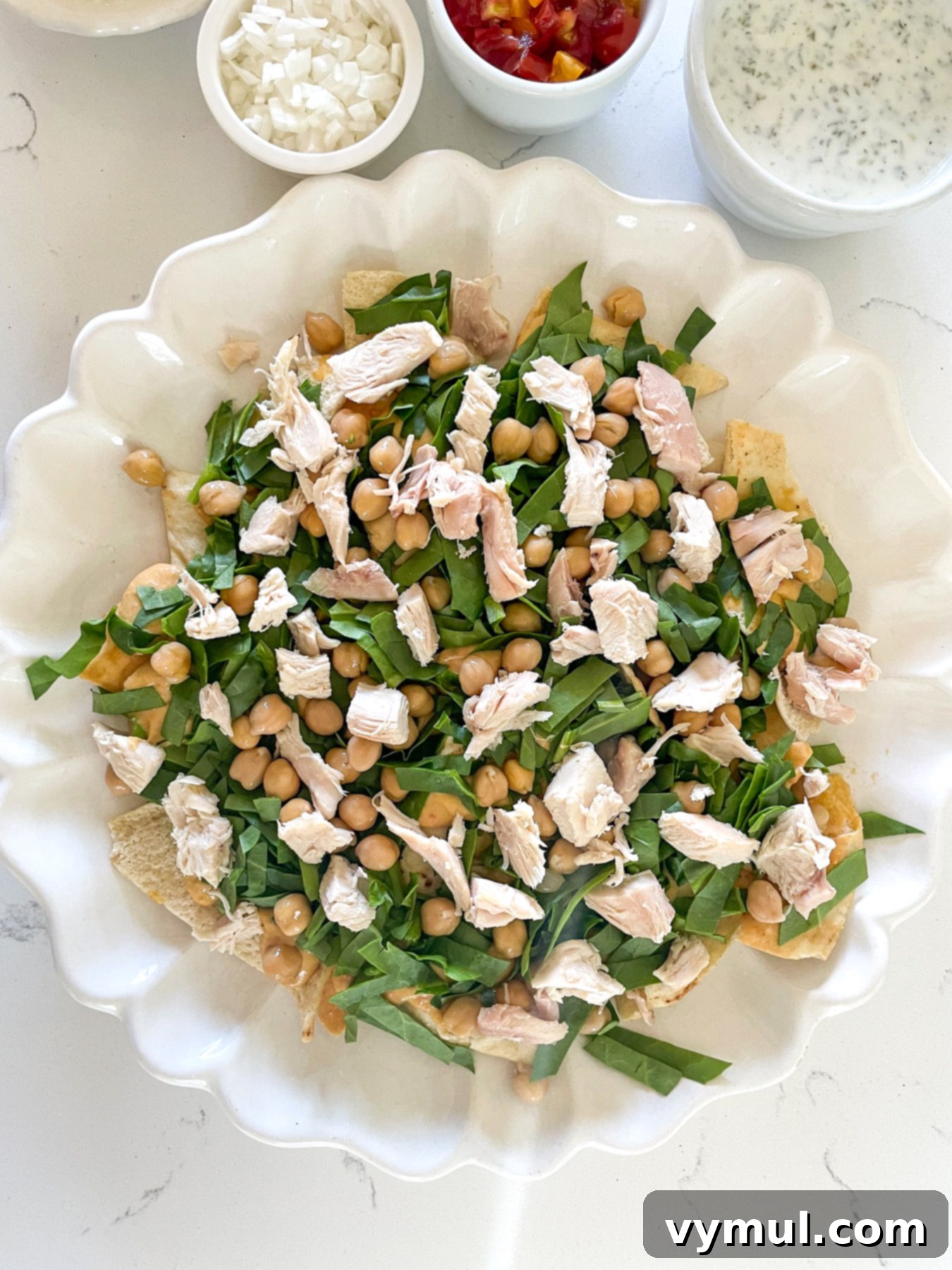 15-Minute No-Bake Greek Nachos 6 hummus, spinach, bean, and chicken layered on pita chips