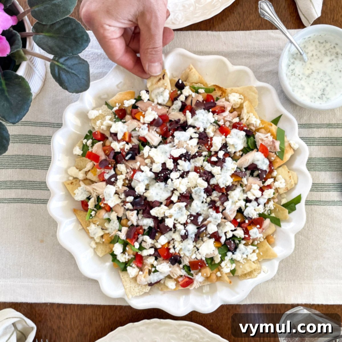 15-Minute No-Bake Greek Nachos 10 Eating nachos from platter