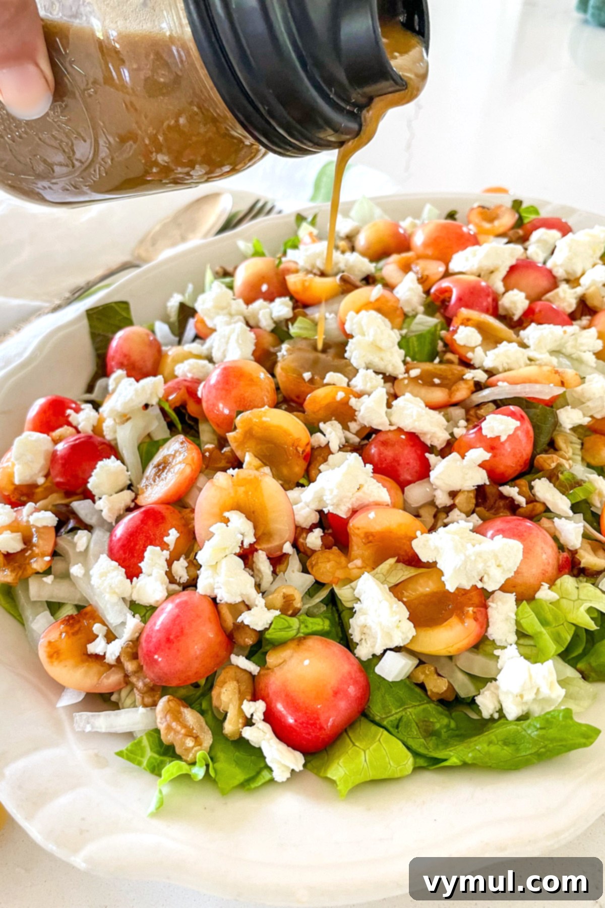 Sweet Cherry, Feta & Walnut Medley 8 pouring balsamic vinaigrette onto cherry salad