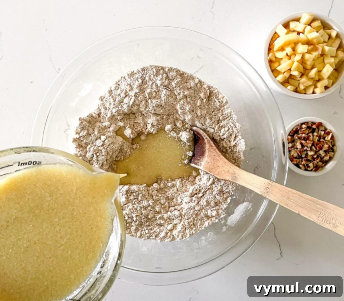 Easy Wholesome Honey Cinnamon Apple Oat Loaf 4 Mixing dry and wet ingredients for apple bread in a large bowl