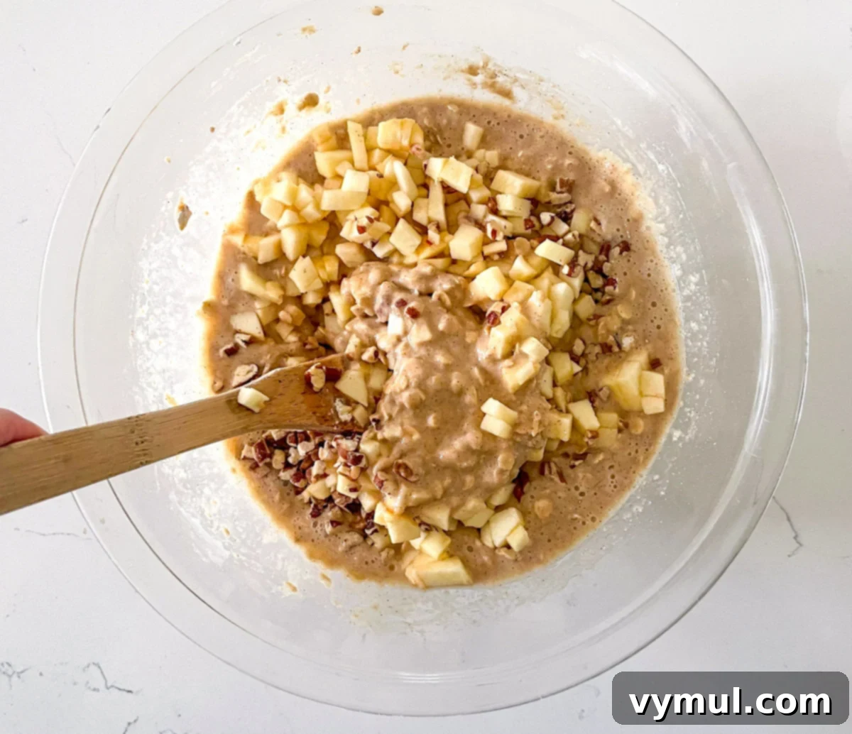 Easy Wholesome Honey Cinnamon Apple Oat Loaf 5 Folding diced apples and chopped nuts into apple bread dough
