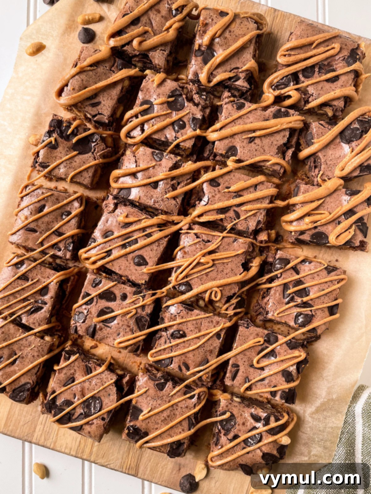 No-Bake Gluten-Free Chocolate Peanut Butter Magic Bars 9 glazed and cut bars on cutting board