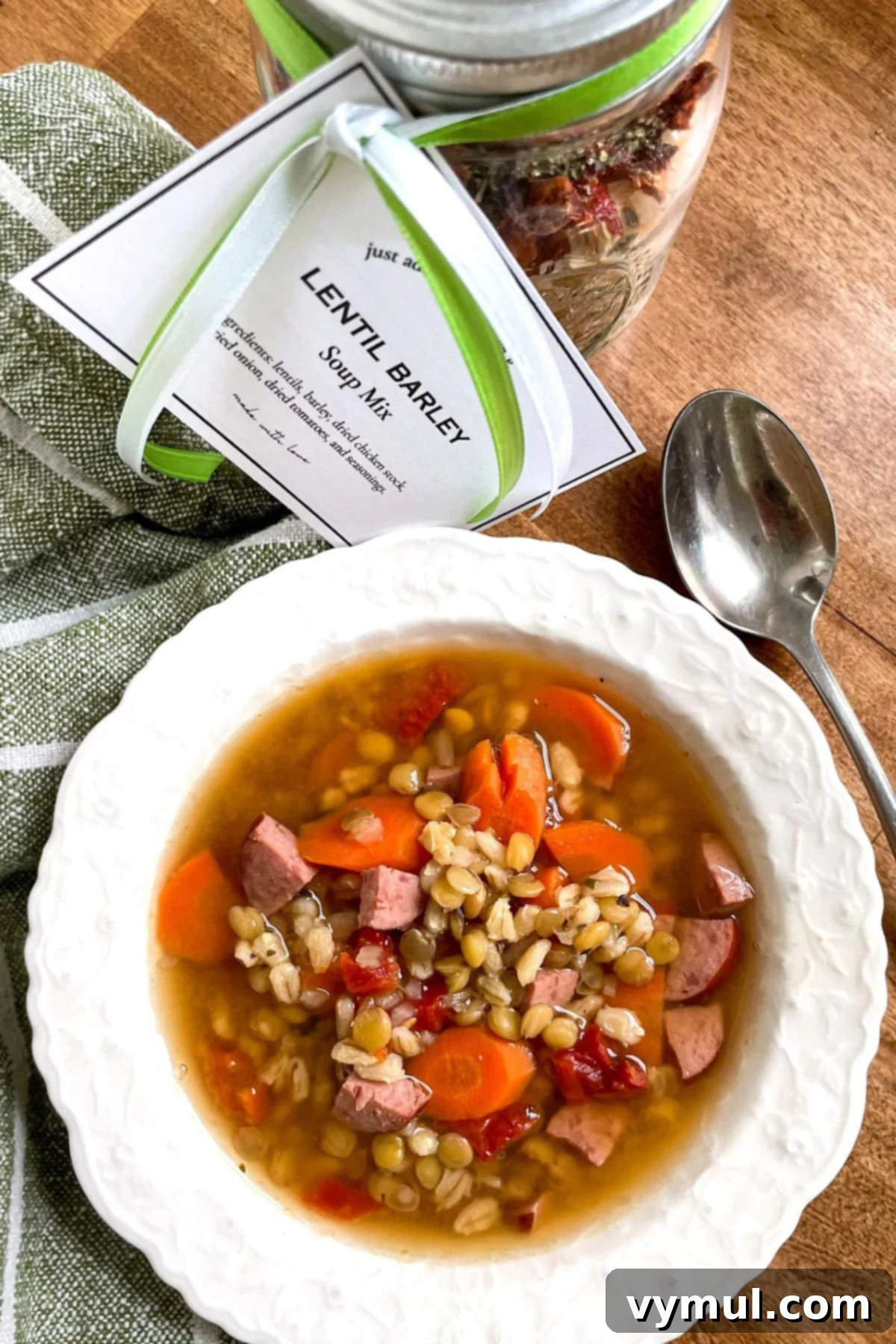 Effortless Homemade Lentil Barley Soup Mix 2 A steaming bowl of homemade lentil barley soup next to a beautifully layered jar of the soup mix, ready for gifting.