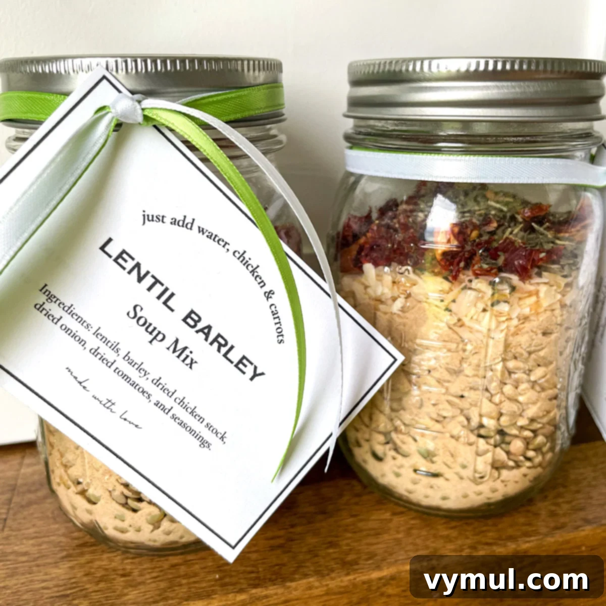 Effortless Homemade Lentil Barley Soup Mix 5 Two clear glass jars showcasing perfectly layered ingredients of lentils, barley, bouillon, dried onions, tomatoes, and seasonings, creating an appealing visual for a gift.