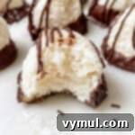 Effortless Coconut Macaroons No Flour No Condensed Milk 10 easy coconut macaroon with a bite out