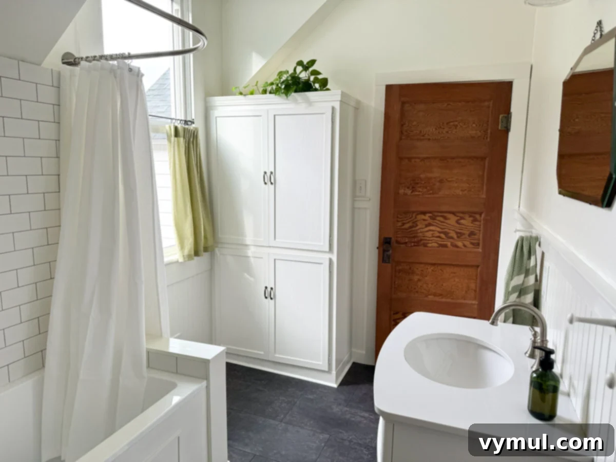 Our Latest Delights Bathroom Transformation Holiday Brunch Austen Puzzle Book Recommendations 6 Revamped built-in bathroom cabinet, original restored window, and a newly installed old fir door with reclaimed hardware, showcasing farmhouse detail.