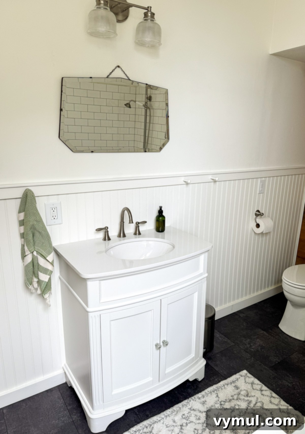 Our Latest Delights Bathroom Transformation Holiday Brunch Austen Puzzle Book Recommendations 8 Vanity area of a beautifully remodeled farmhouse bathroom, featuring a white vanity, mirror, and updated fixtures, blending classic style with modern comfort.