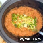 Hands-Off 5-Ingredient Taco Dip for Slow Cooker and Instant Pot 10 Taco dip with fresh toppings ready to be served from the slow cooker.