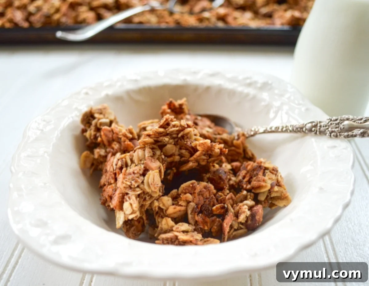 Healthy Quick Maple Honey Granola Bark Clusters 5 A white bowl filled with finished homemade maple honey granola, showing off its generous clusters and golden texture.