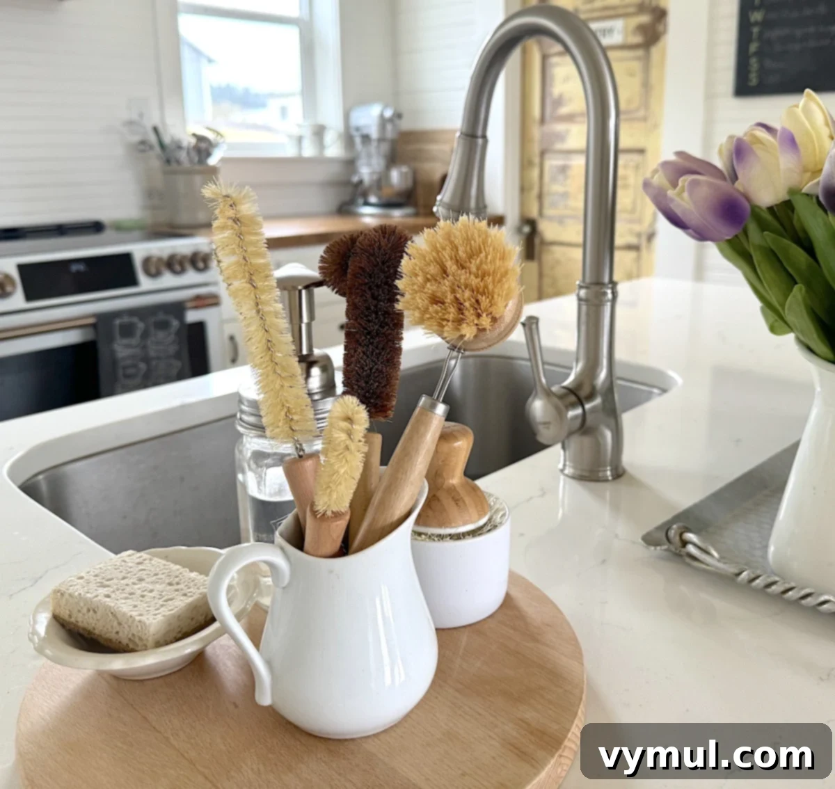 A collection of natural bristle brushes, displayed aesthetically in a white pitcher beside a sink, promoting eco-friendly kitchen practices.