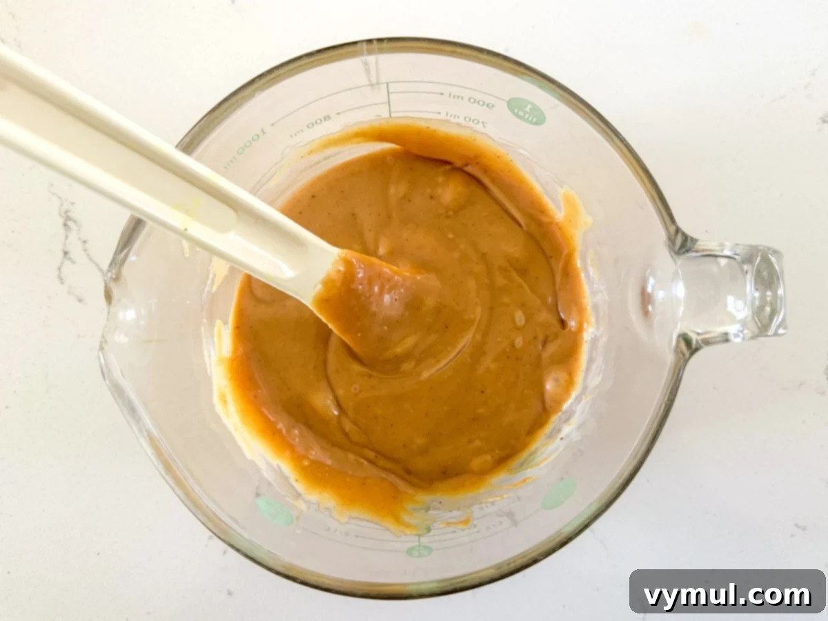 Step 4: Sweetened condensed milk and peanut butter are mixed together in a small bowl to create the filling.