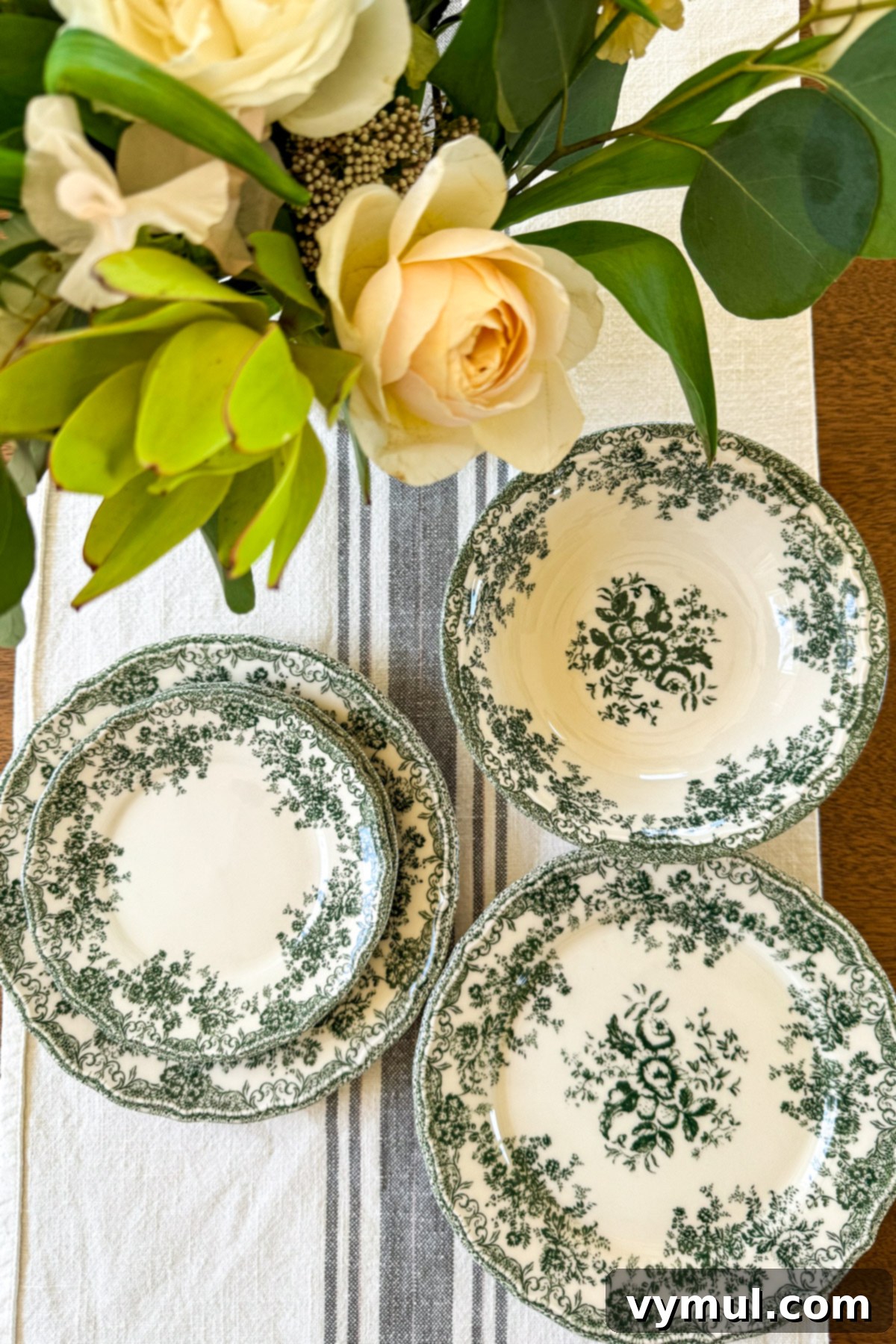 71 Good Things: Orchard Tips, Vintage Kitchen Inspiration, and Six Must-Read Books 6 green floral plates and bowls on striped cloth with flowers