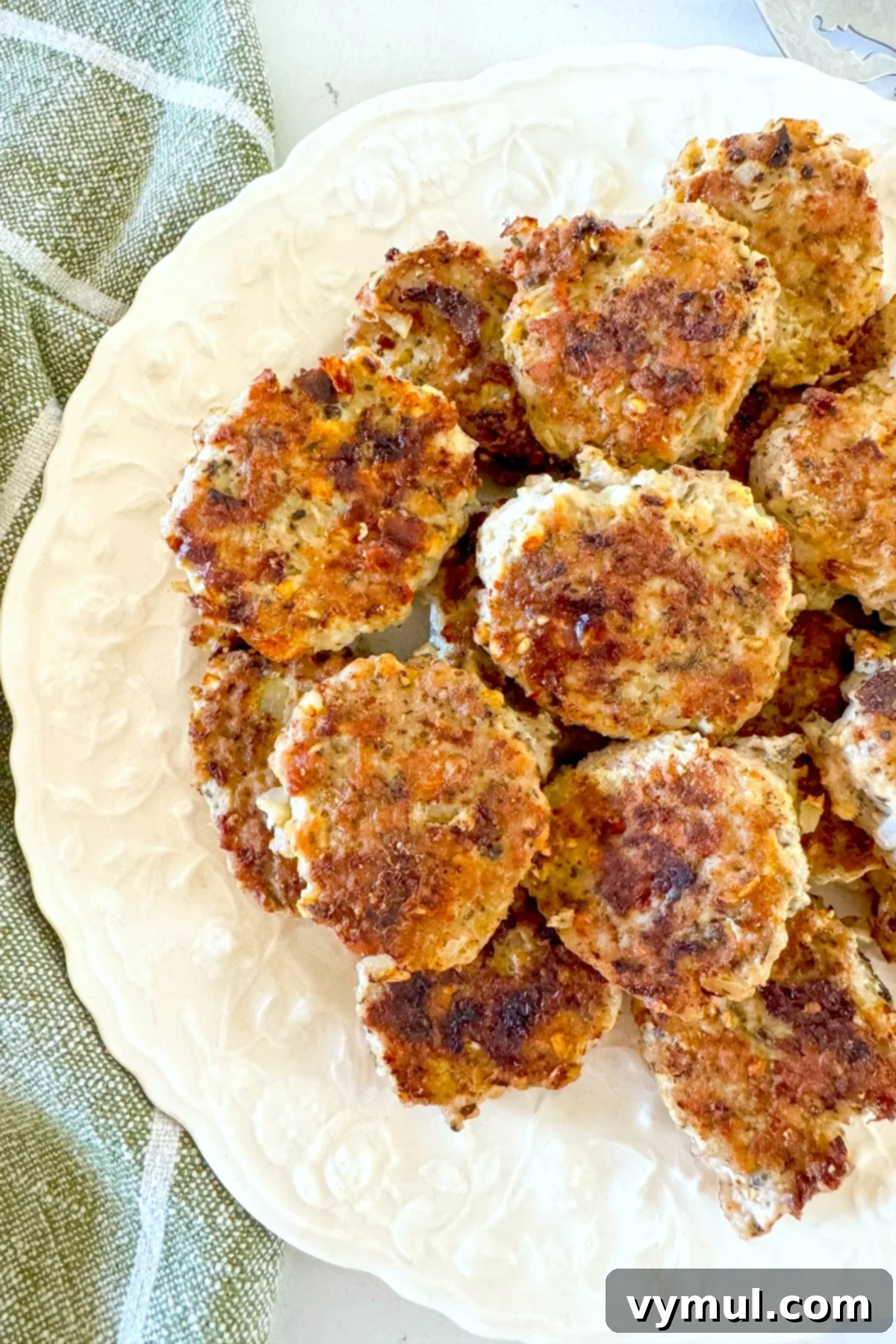 Speedy Wholesome Turkey Patties for Busy Mornings 7 A plate of golden brown, healthy breakfast turkey patties, viewed from above, showcasing their appetizing appearance and readiness for a meal.
