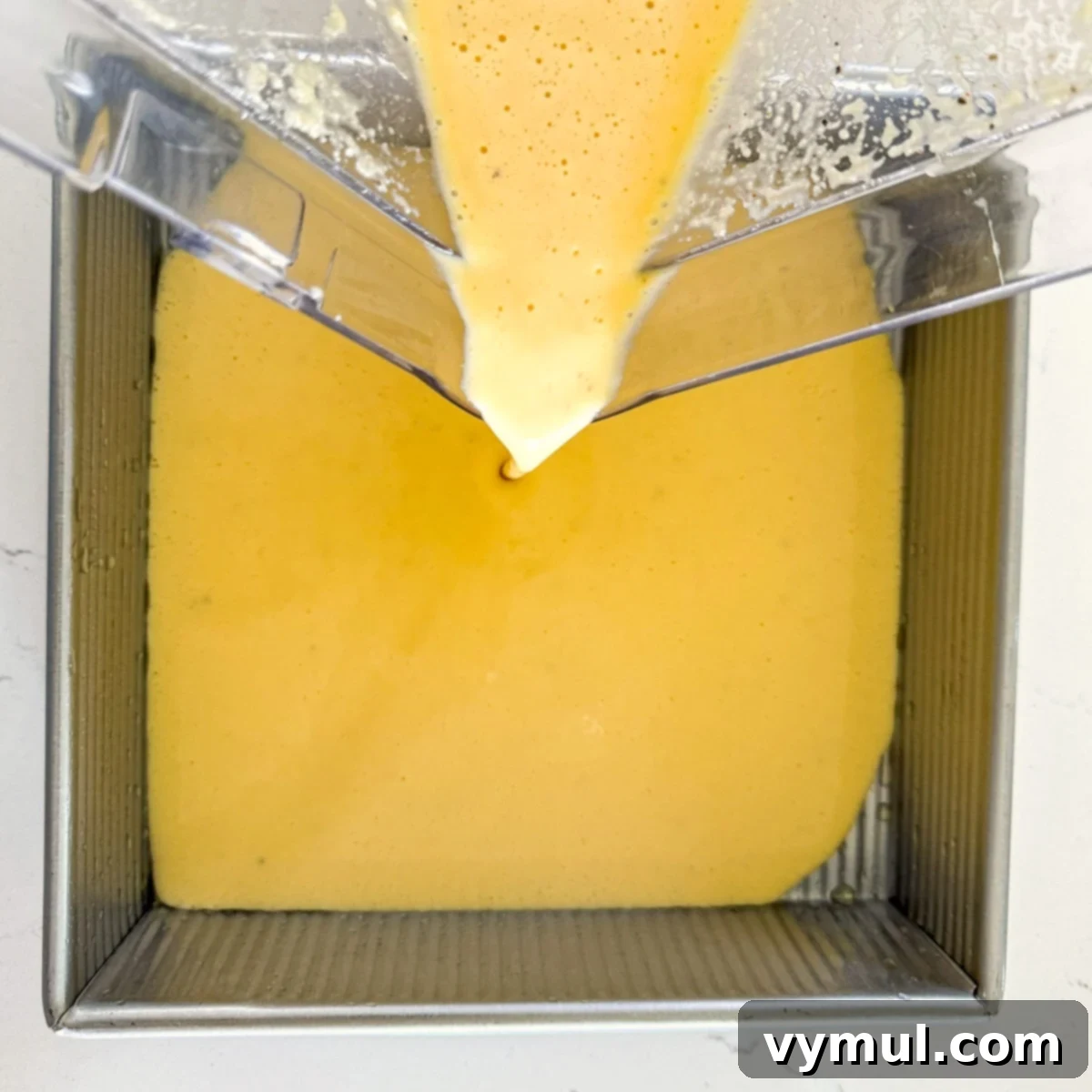 Protein-Packed Make-Ahead Cottage Cheese Eggs 6 Pouring the blended high protein egg mixture into a prepared baking pan.