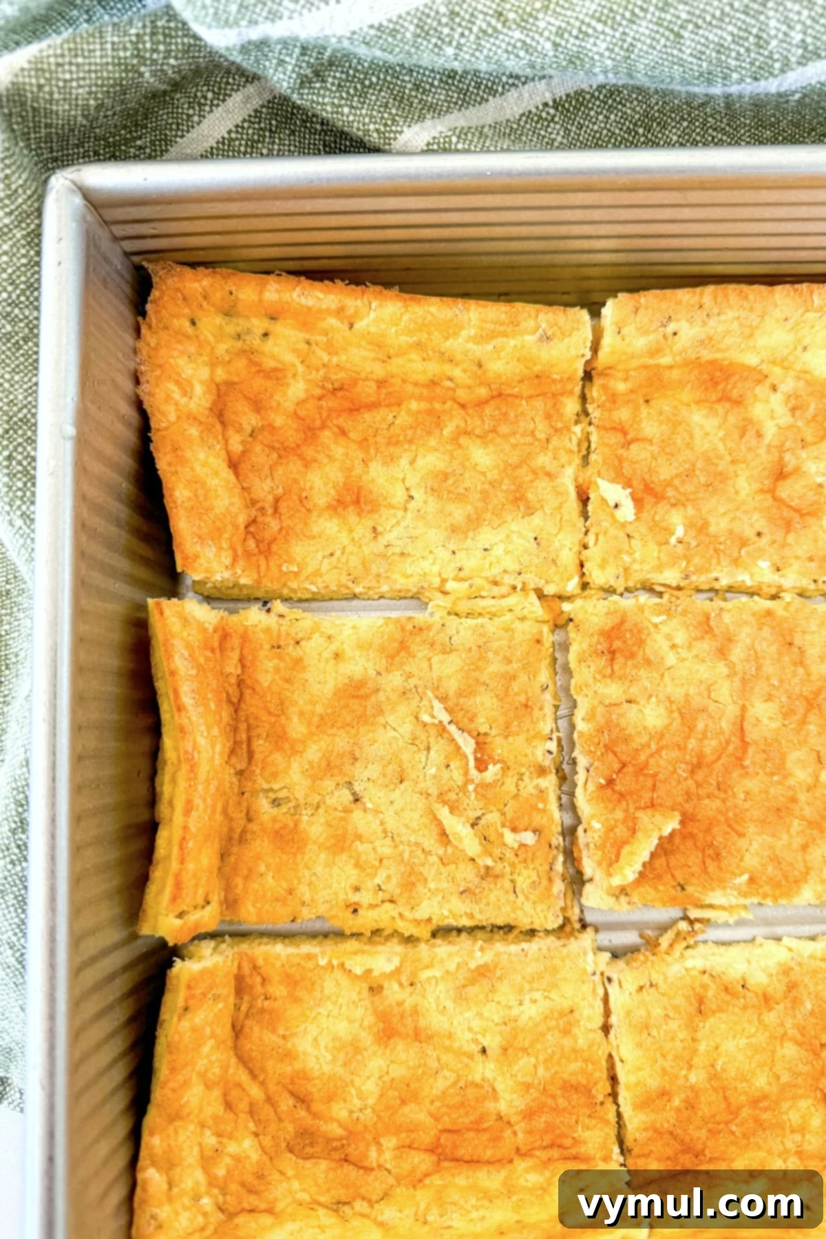 Protein-Packed Make-Ahead Cottage Cheese Eggs 8 High protein eggs cut into individual serving pieces inside the baking pan, ready for enjoyment or meal prep.