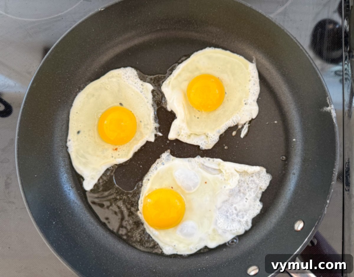 Speedy Six Ingredient High Protein Mexican Breakfast Bowls 5 A fried egg with a perfectly runny yolk cooking in a skillet.