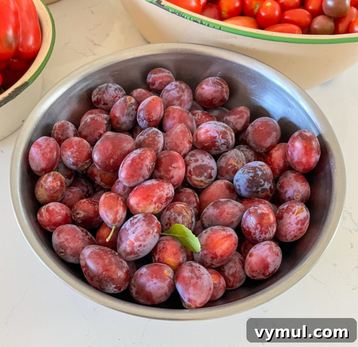 Good Things Lately 76 Garden Wisdom Harvest Joys Kitchen Wins and Reading Picks 6 small ripe plums in silver bowl
