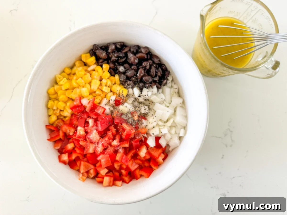 Zesty 10 Minute Black Bean and Corn Salad 5 combining black bean ingredients in a white bowl