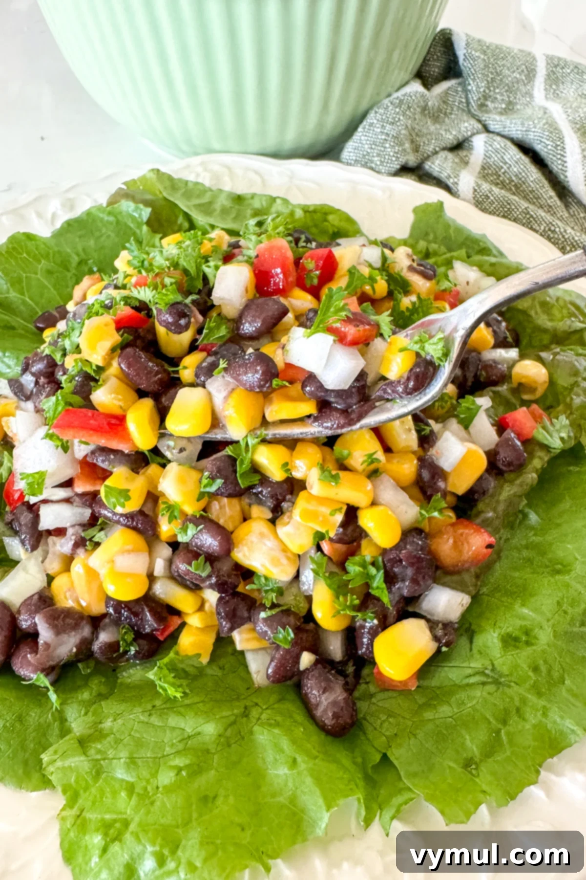 Zesty 10 Minute Black Bean and Corn Salad 7 fork full of black bean salad over plate