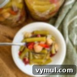 Small white bowl filled with a delicious serving of three bean salad.