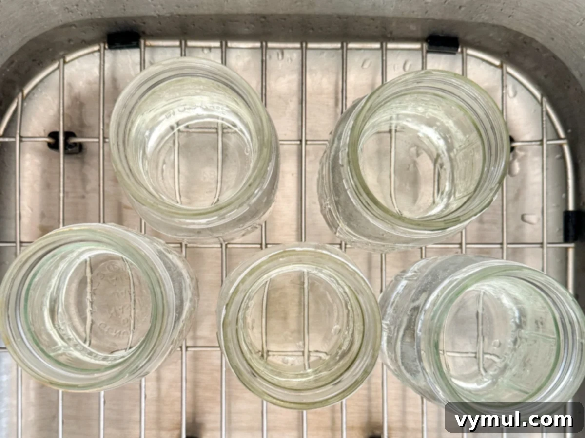 Washing and preparing canning jars and lids on a counter for making three bean salad.