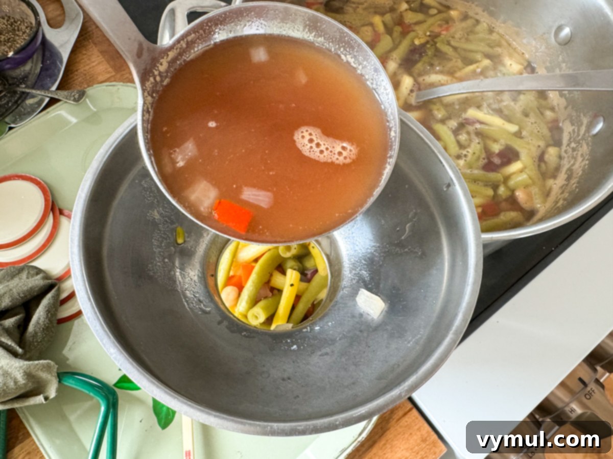 Ladling hot brine liquid into a canning jar filled with three bean salad, maintaining proper headspace.