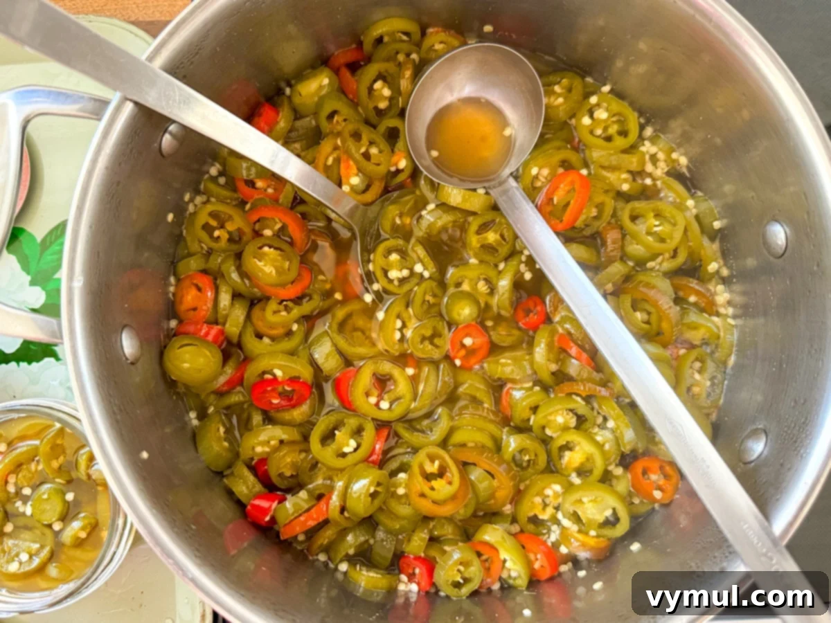 Sweet and Spicy Lower Sugar Cowboy Candy for Easy Canning 6 Cooking peppers with syrup in large pot