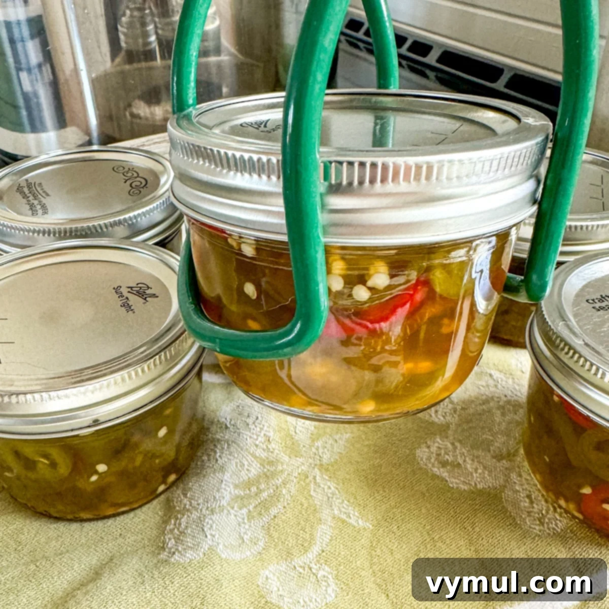Sweet and Spicy Lower Sugar Cowboy Candy for Easy Canning 8 removing canned peppers from canner