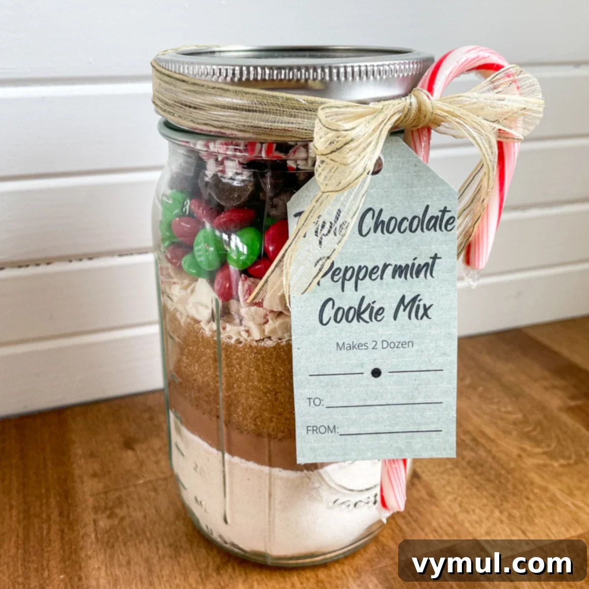 Triple Chocolate Peppermint Cookie Jar Mix with Printable Tags 5 A close-up of a perfectly layered triple chocolate peppermint cookie mix in a jar, showcasing its festive tag.