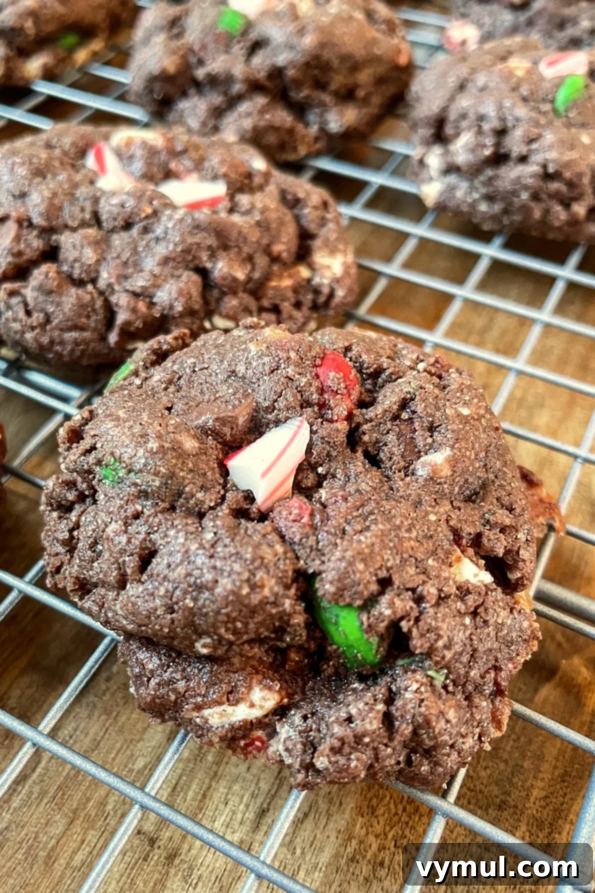 Triple Chocolate Peppermint Cookie Jar Mix with Printable Tags 6 Freshly baked triple chocolate peppermint cookies cooling on a wire rack, showing off their rich color and festive toppings.