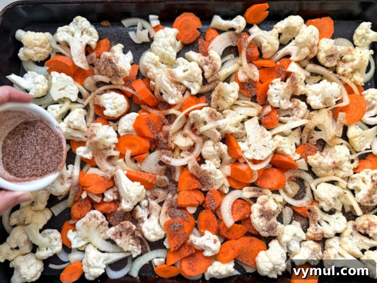 Simple Healthy Chili Roasted Cauliflower and Carrots 4 seasoning cauliflower and carrots on sheet pan