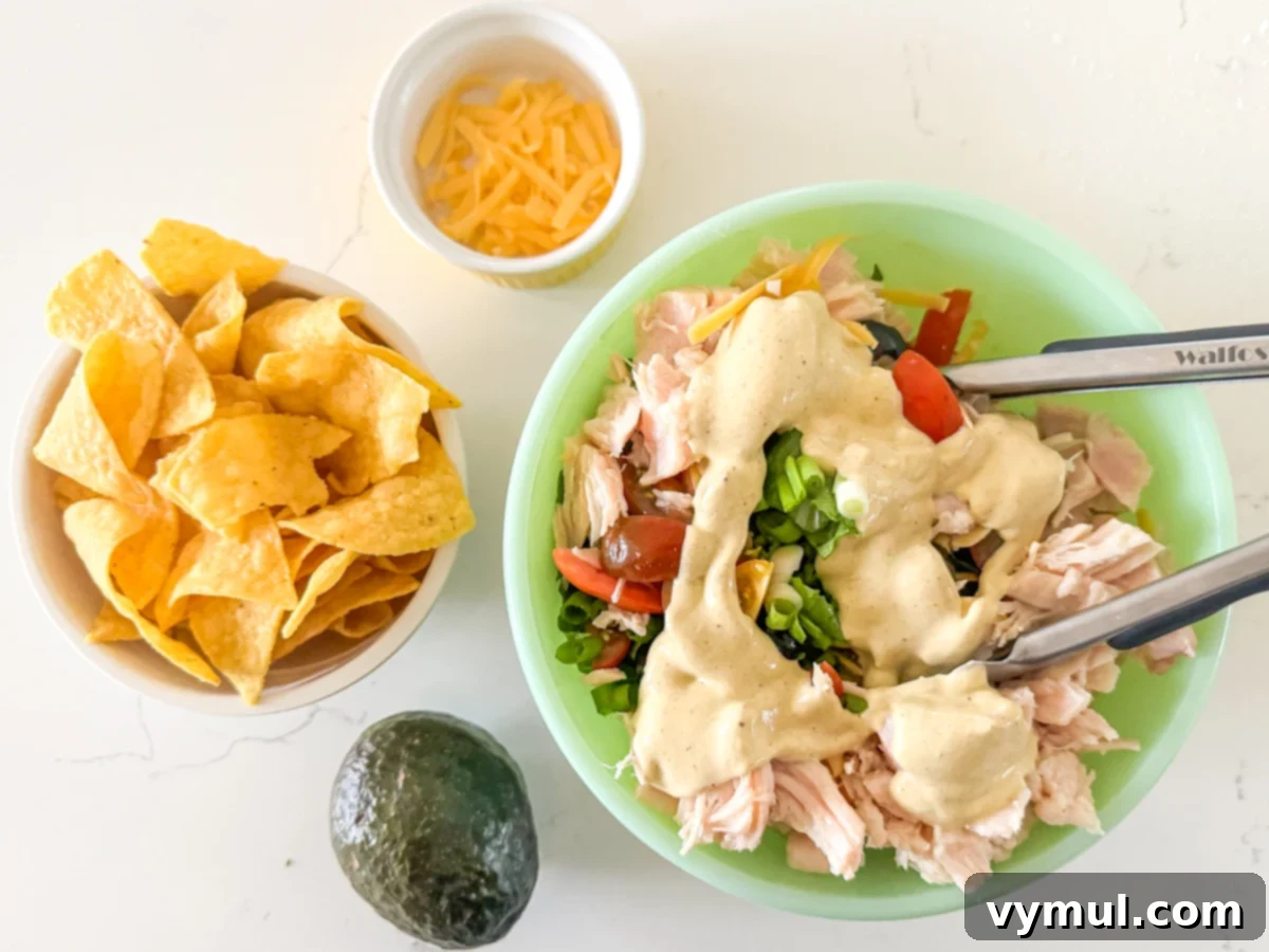 15-Minute Fiesta: Creamy Avocado Salad with Zesty Avocado Dressing 5 mixing up the salad ingredients with tongs