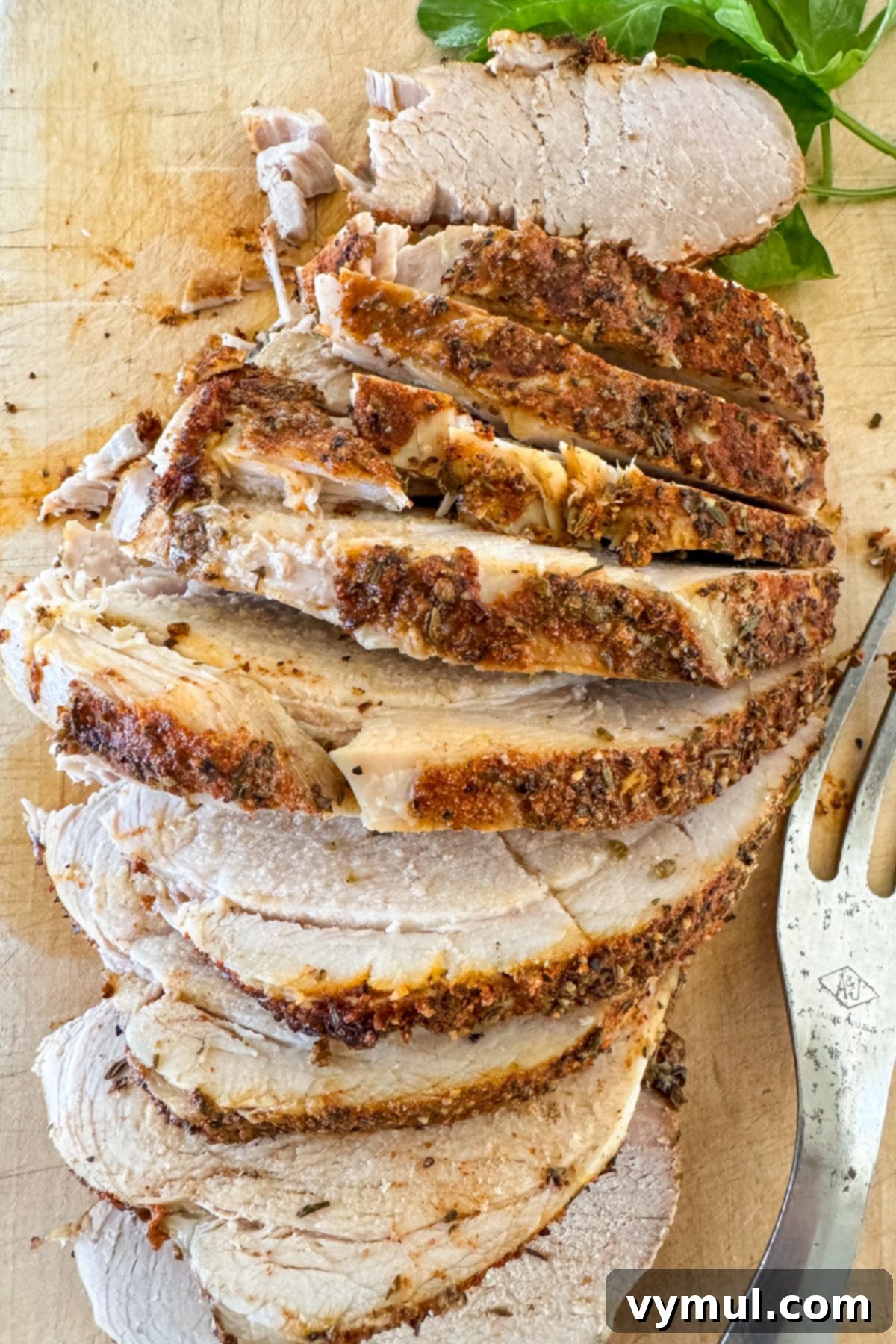 sliced slow cooker pork sirloin roast on cutting board