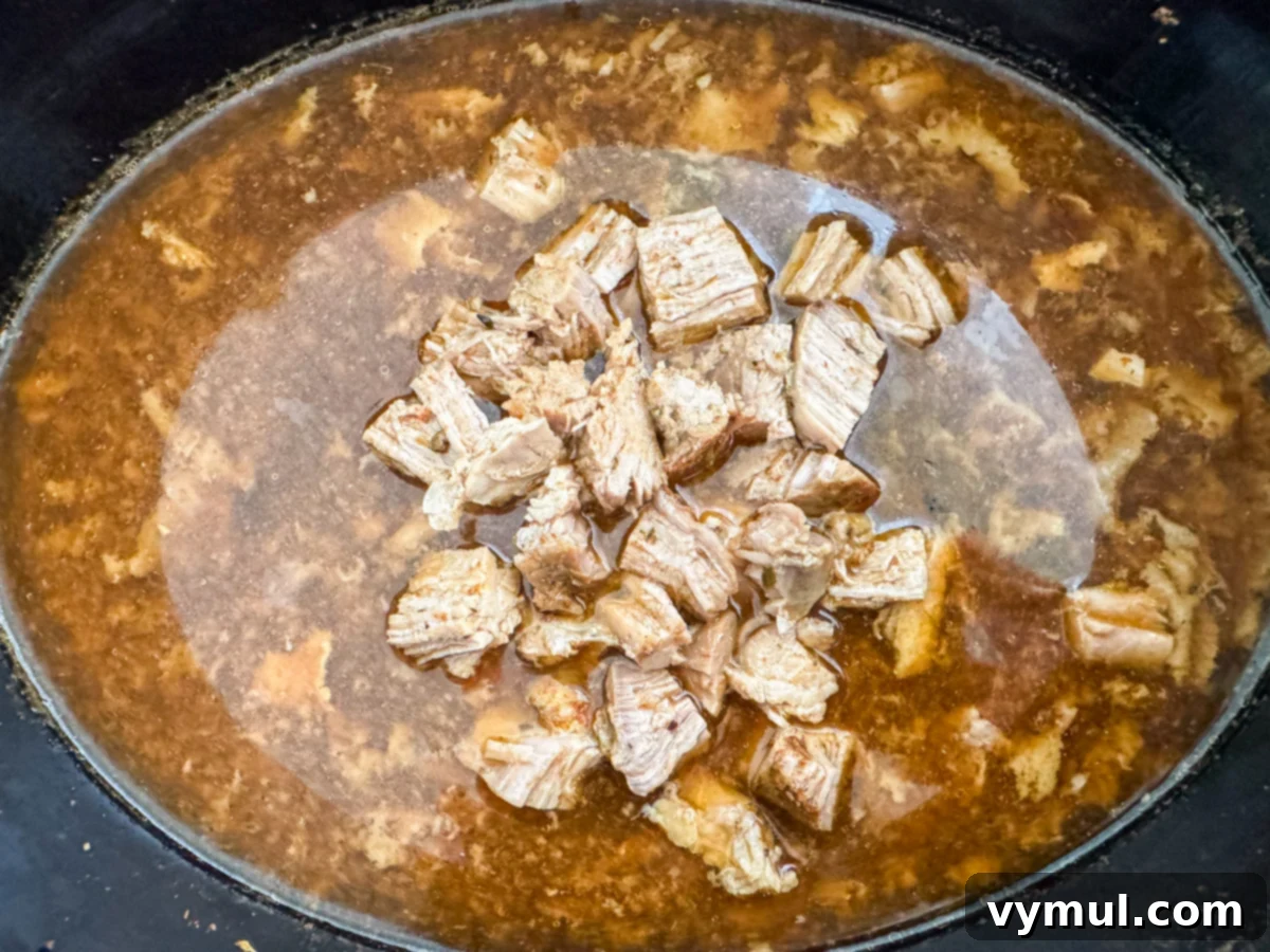 shredded pork added to slow cooker juices