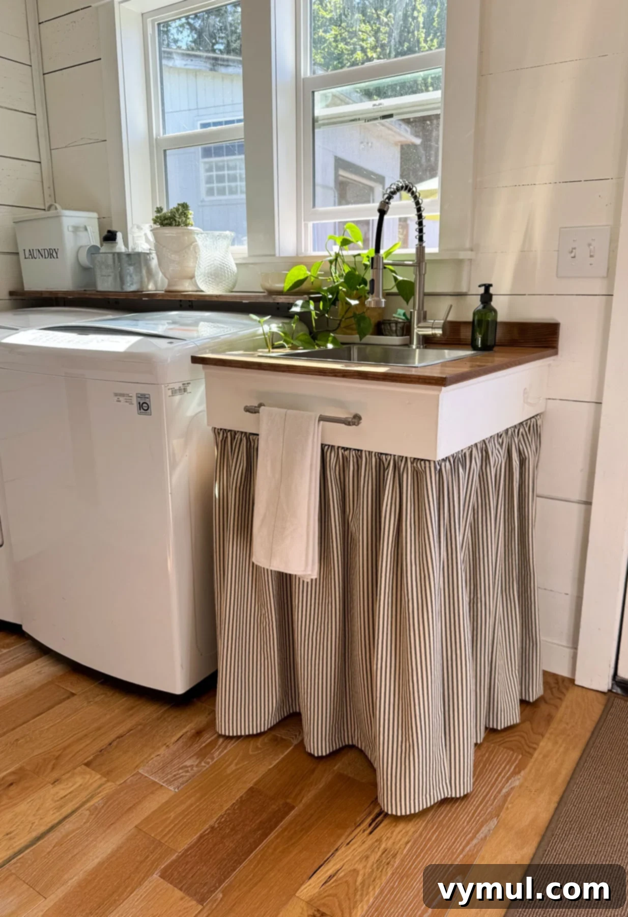 Laundry room sink with wood counter and fabric skirt