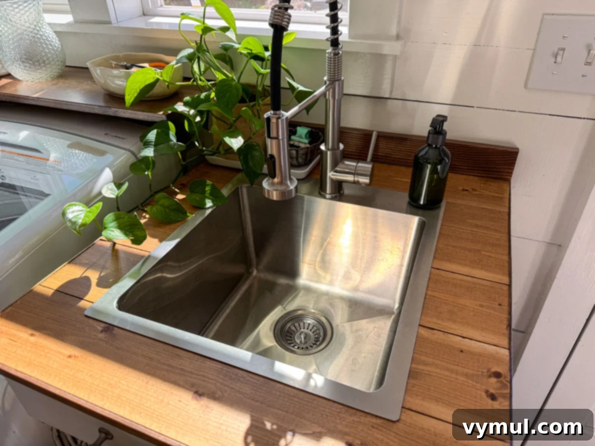 laundry stainless sink and gooseneck faucet in wood counter